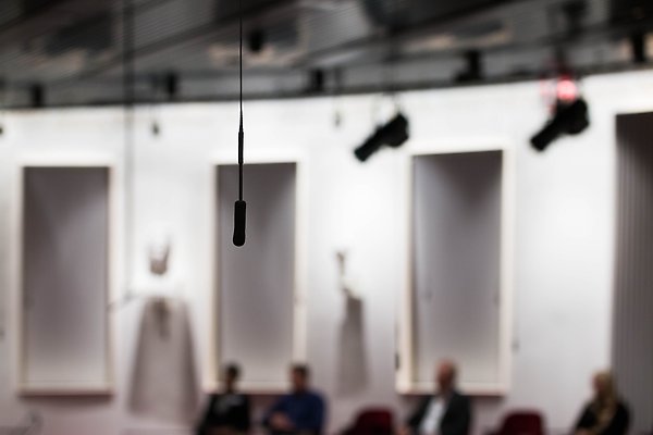 Microphone hangs from the ceiling in an auditorium